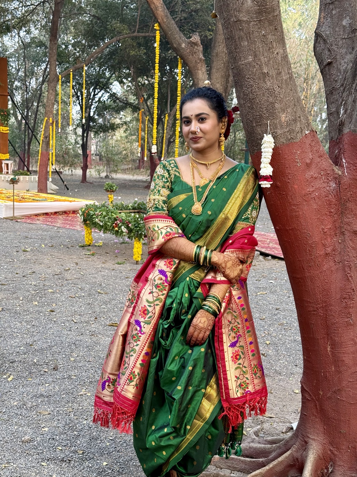 Bride in a green nauvari saree with mehendi and soft bridal makeup