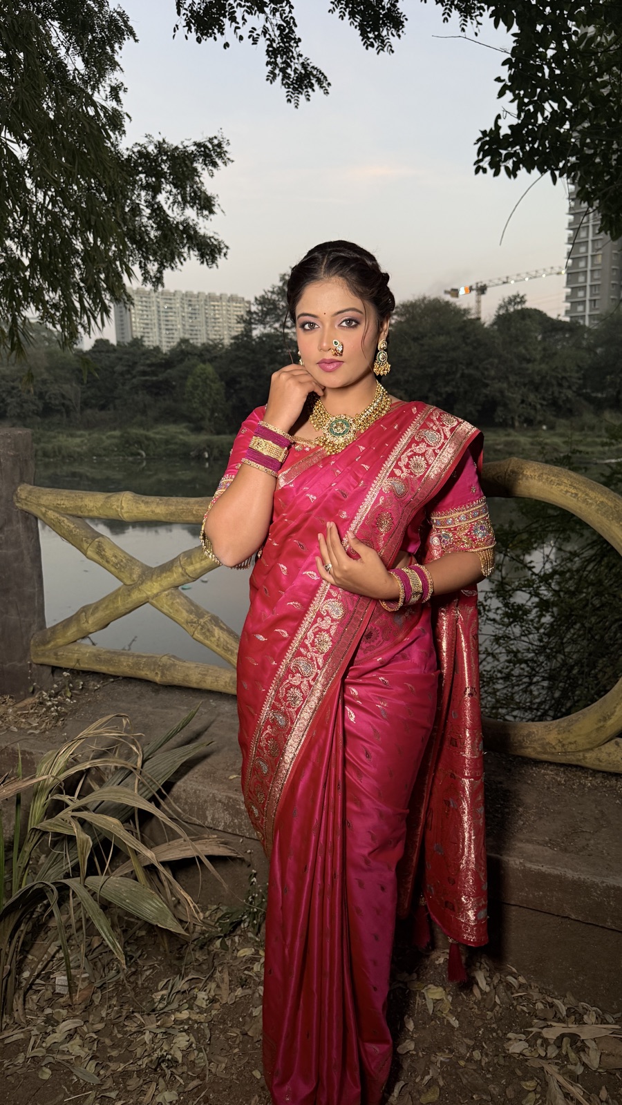 Guest glam look in a pink saree, photographed outdoors